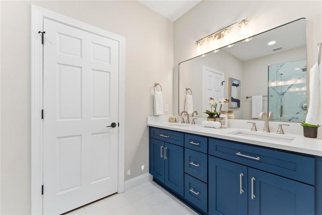 2990 Shallowford Road Atlanta, GA 30341 - Photo 12 of 34 a bathroom with a double vanity sink and a mirror