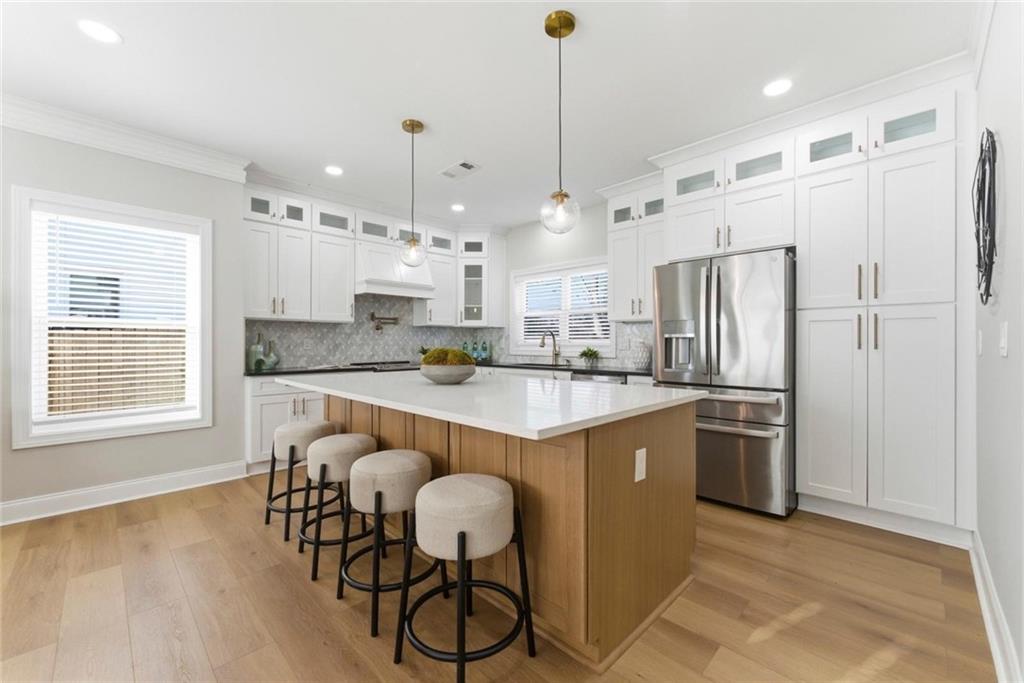 2990 Shallowford Road Atlanta, GA 30341 - Photo 4 of 34 a kitchen with stainless steel appliances granite countertop a refrigerator a sink dishwasher a stove and a dining table with wooden floor