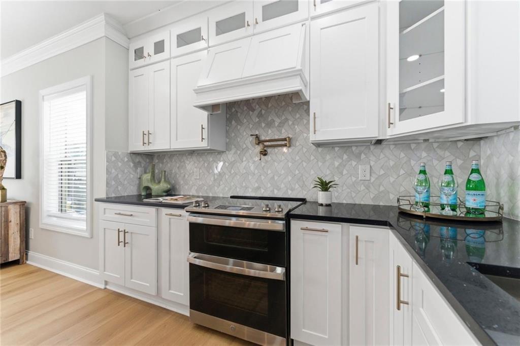 2990 Shallowford Road Atlanta, GA 30341 - Photo 6 of 34 a kitchen with stainless steel appliances granite countertop white cabinets sink and stove