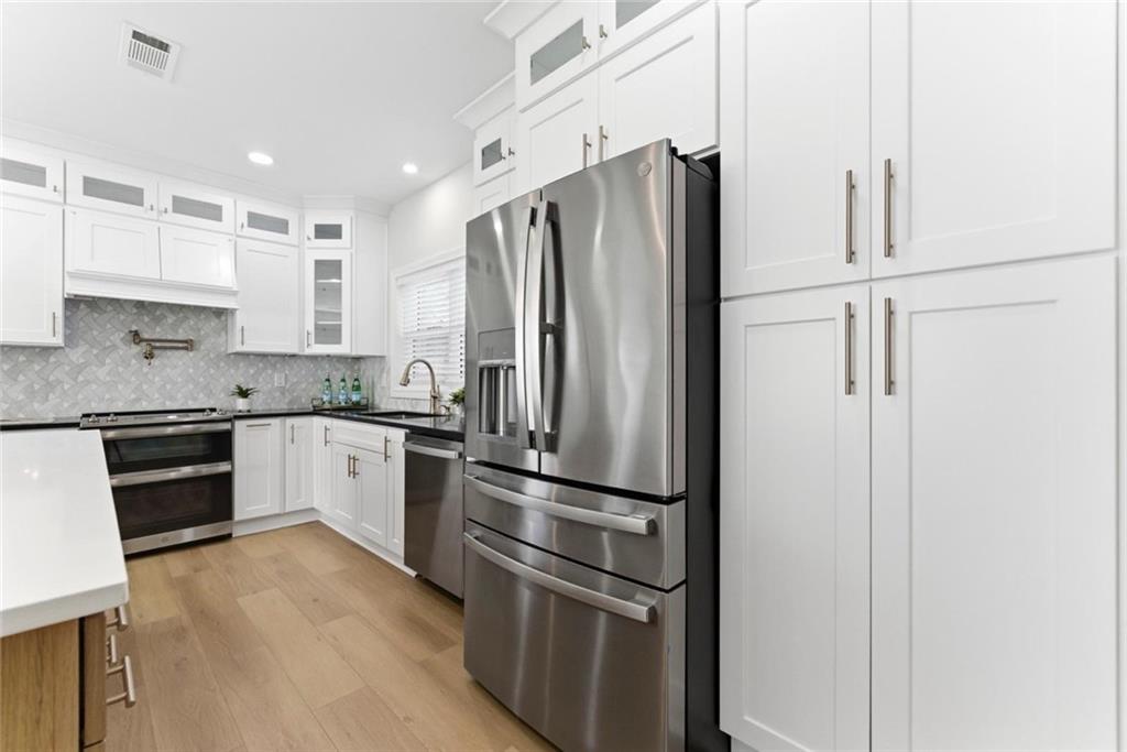 2990 Shallowford Road Atlanta, GA 30341 - Photo 7 of 34 a kitchen with stainless steel appliances and refrigerator