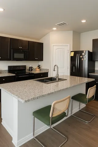 a kitchen with a refrigerator and a sink