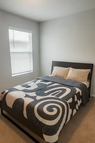 a bedroom with a bed and a window