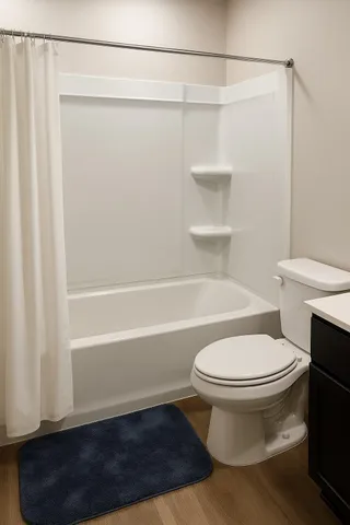 a bathroom with a toilet and a shower