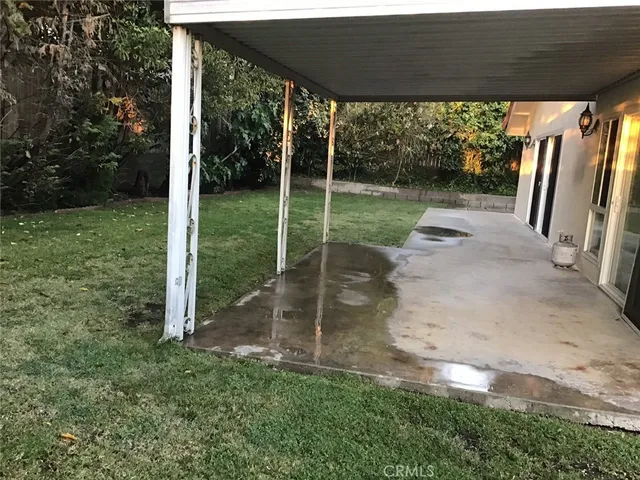 a view of a chair and table in the garden