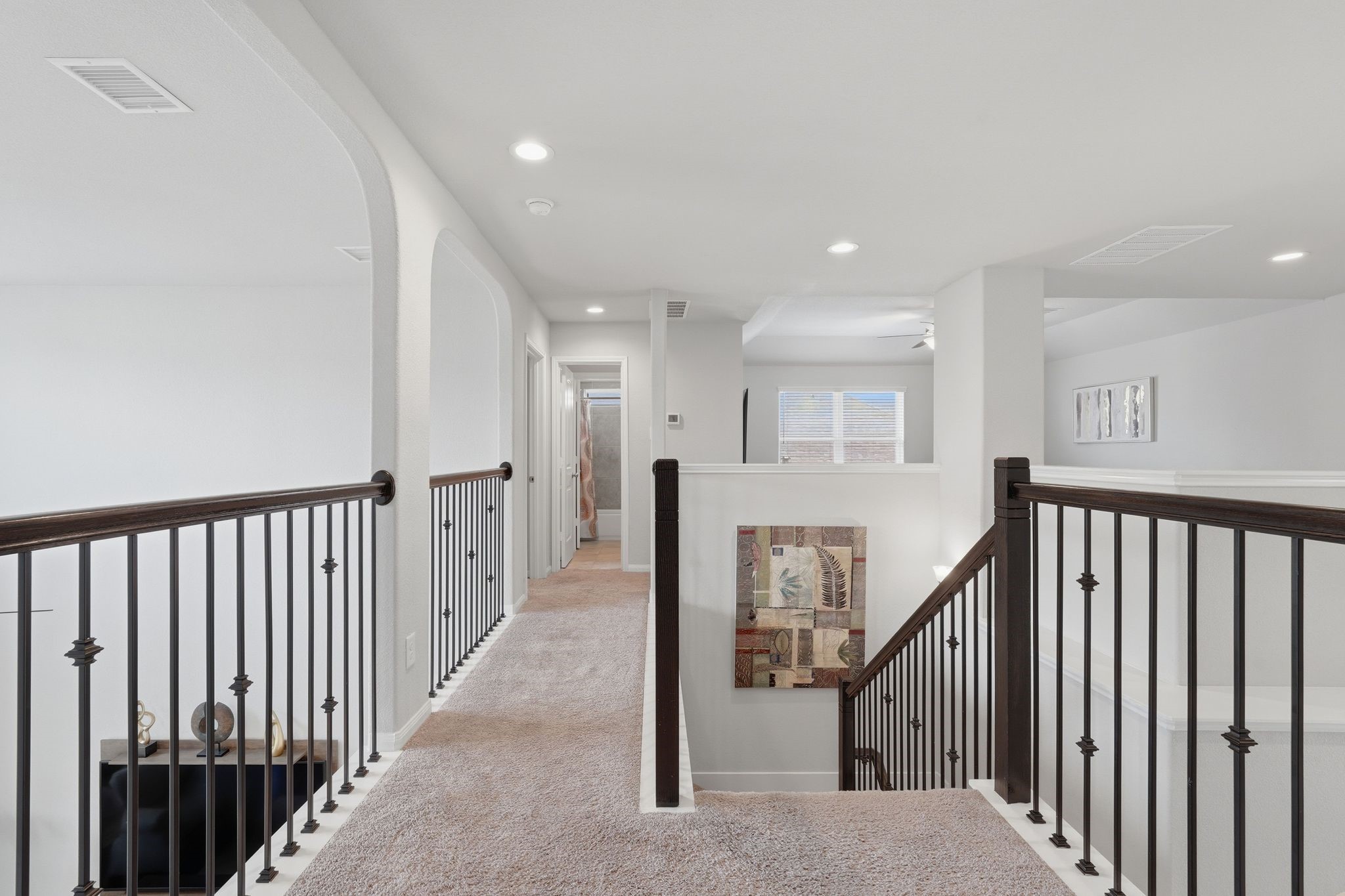 7522 Windsor View Drive Spring, TX 77379 - Photo 22 of 49 Open upstairs hallway with iron railing details and views overlooking the main living area.