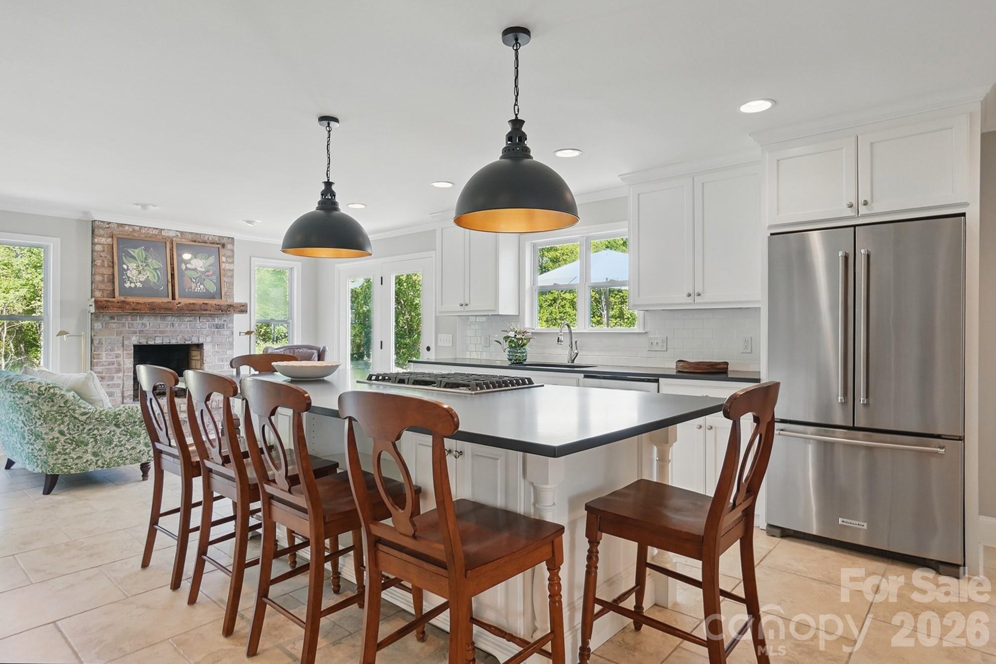 411 Baucom Deese Road Monroe, NC 28110 - Photo 11 of 45 a kitchen with stainless steel appliances a dining table chairs and granite counter tops