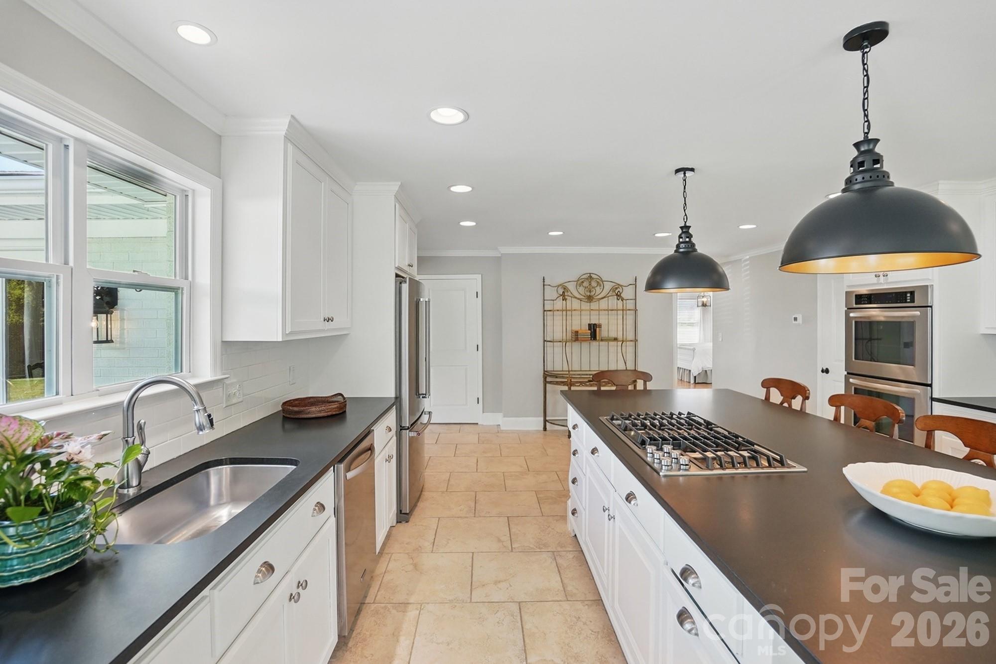 411 Baucom Deese Road Monroe, NC 28110 - Photo 14 of 45 a kitchen with stainless steel appliances granite countertop a sink a stove and a wooden floors