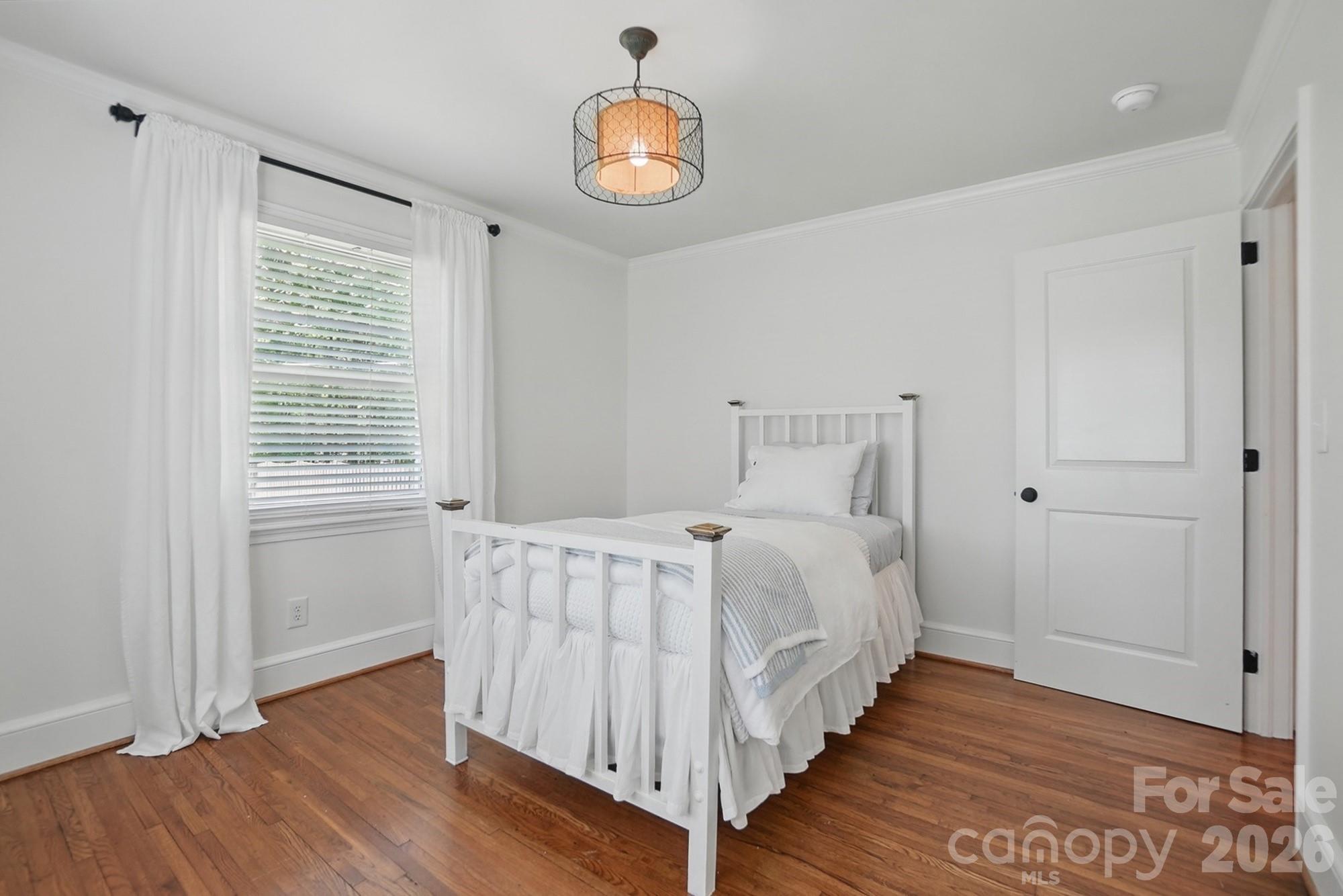 411 Baucom Deese Road Monroe, NC 28110 - Photo 25 of 45 a bedroom with a bed and wooden floor