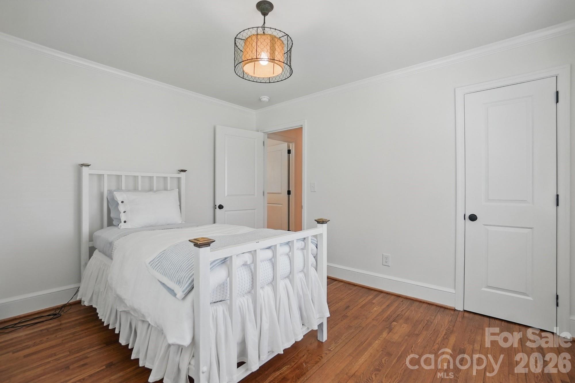 411 Baucom Deese Road Monroe, NC 28110 - Photo 26 of 45 a bedroom with a bed and wooden floor