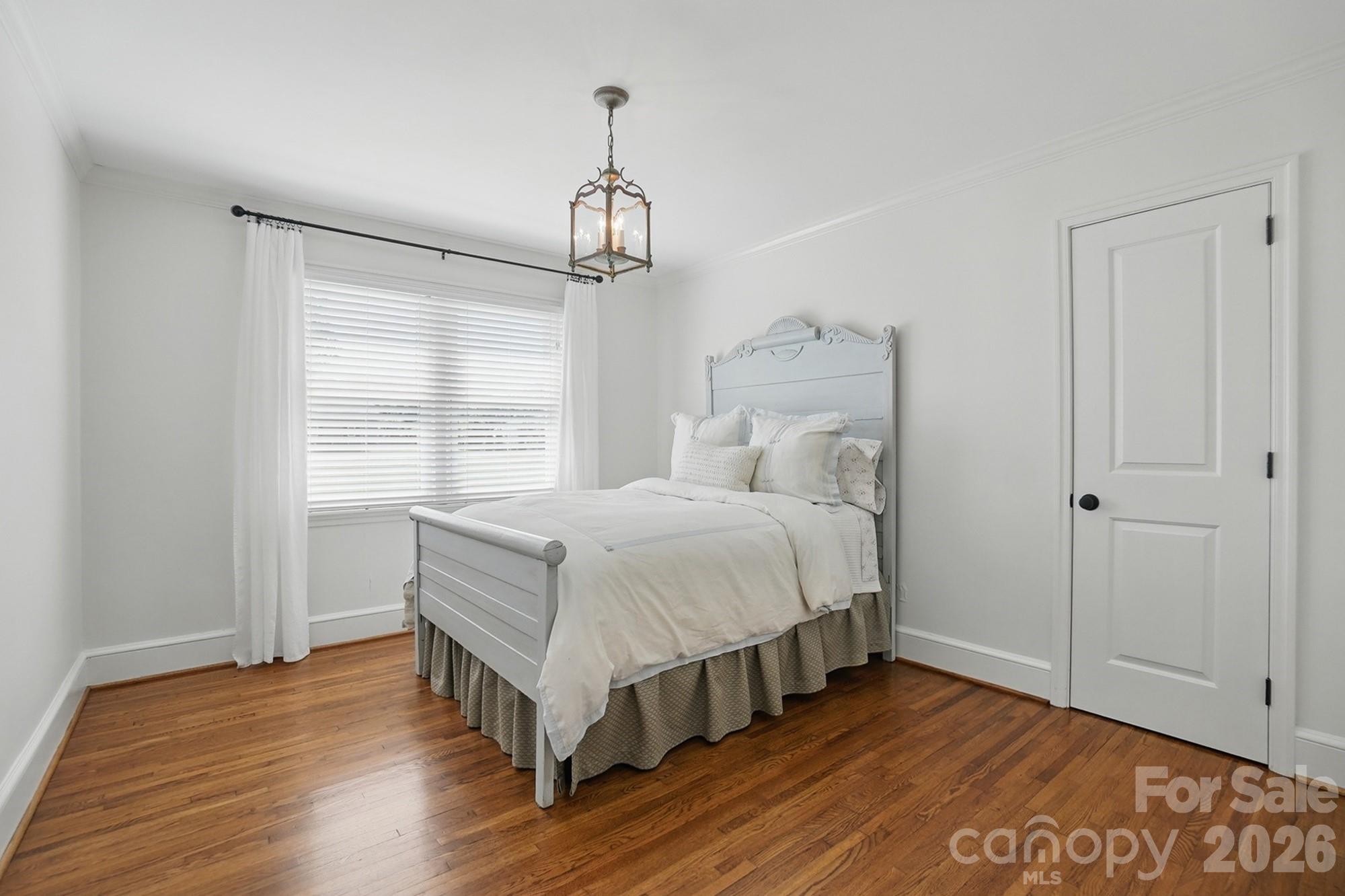 411 Baucom Deese Road Monroe, NC 28110 - Photo 29 of 45 a bedroom with a bed and wooden floor
