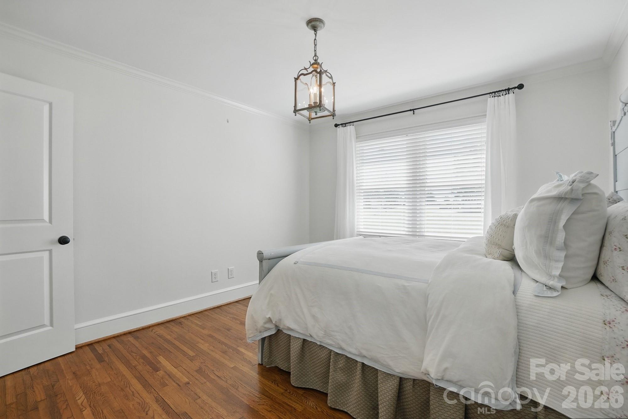 411 Baucom Deese Road Monroe, NC 28110 - Photo 30 of 45 a bedroom with a bed and wooden floor