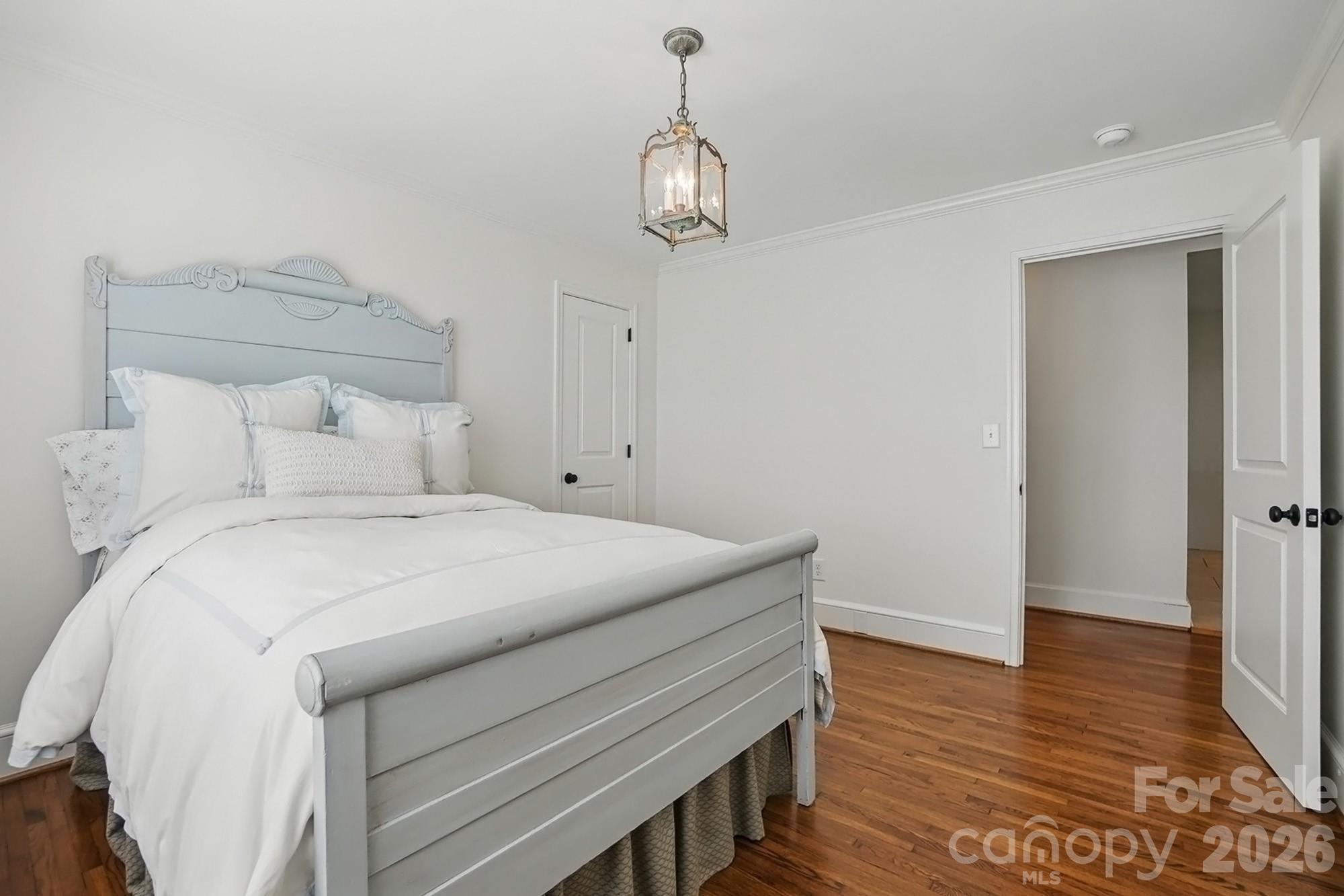 411 Baucom Deese Road Monroe, NC 28110 - Photo 31 of 45 a bedroom with a bed and wooden floor