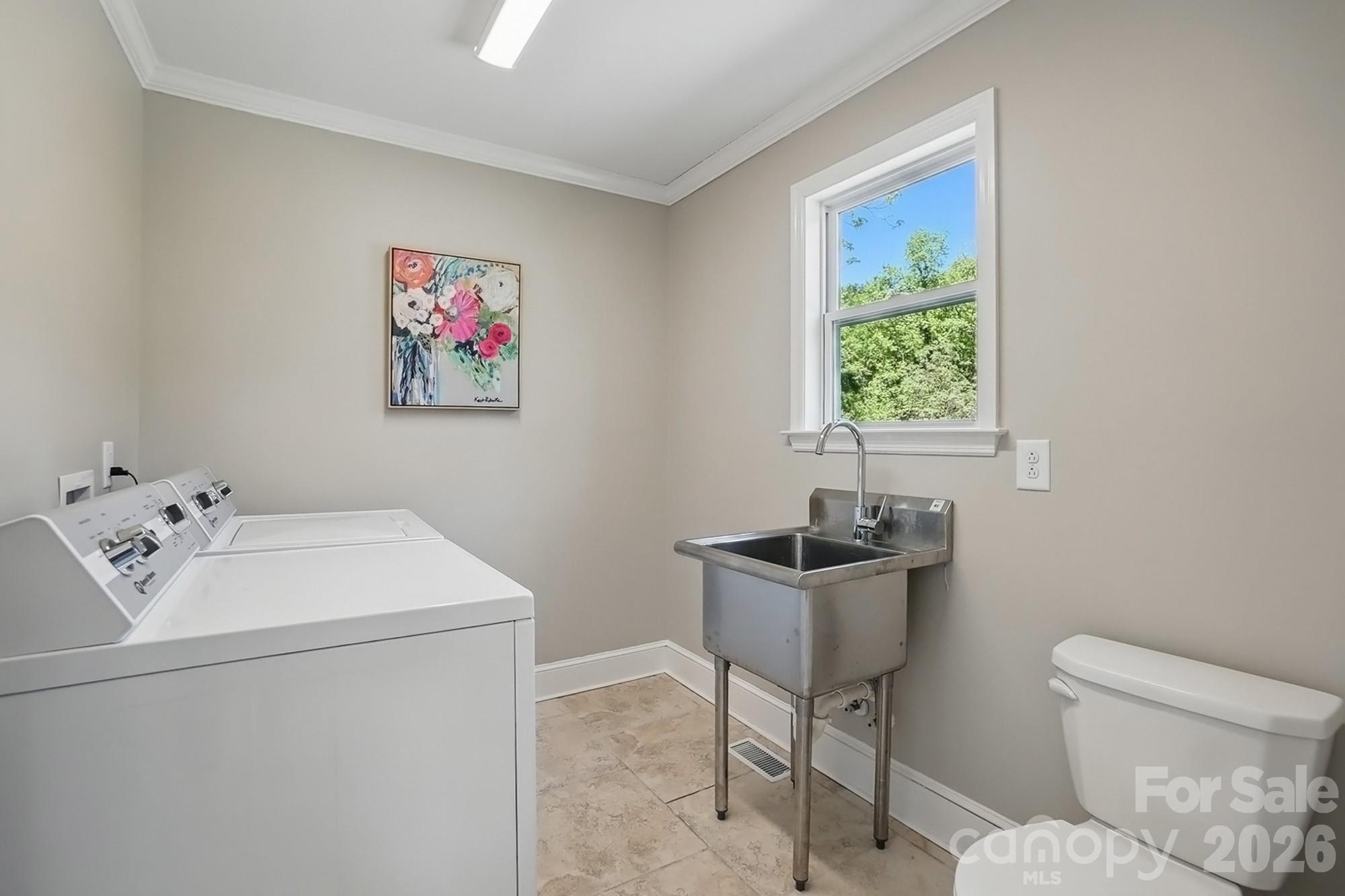 411 Baucom Deese Road Monroe, NC 28110 - Photo 32 of 45 a bathroom with a sink toilet and a window