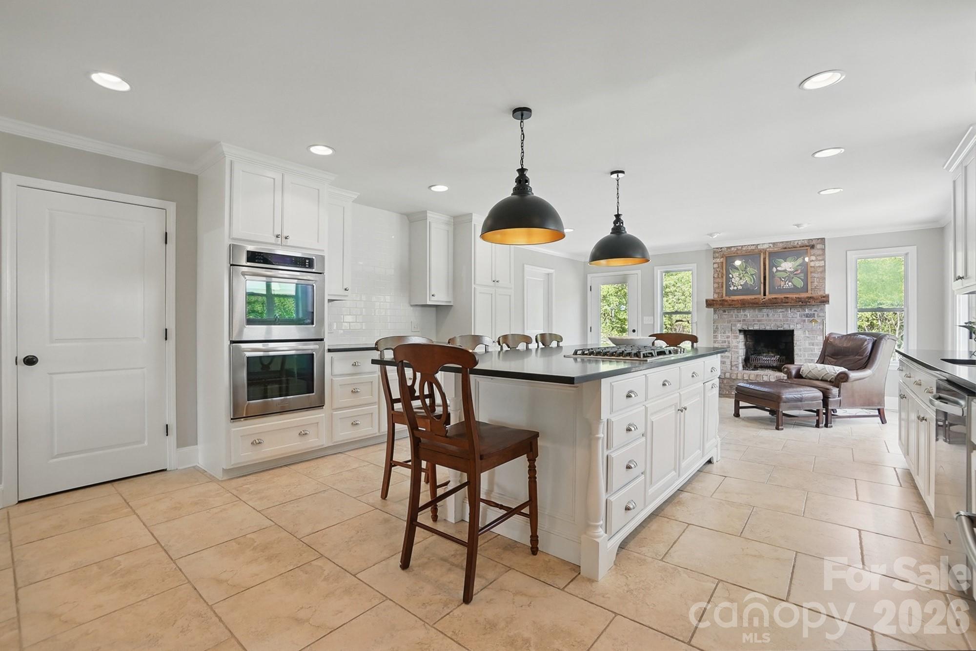 411 Baucom Deese Road Monroe, NC 28110 - Photo 9 of 45 a kitchen with stainless steel appliances kitchen island granite countertop a stove a sink and a refrigerator