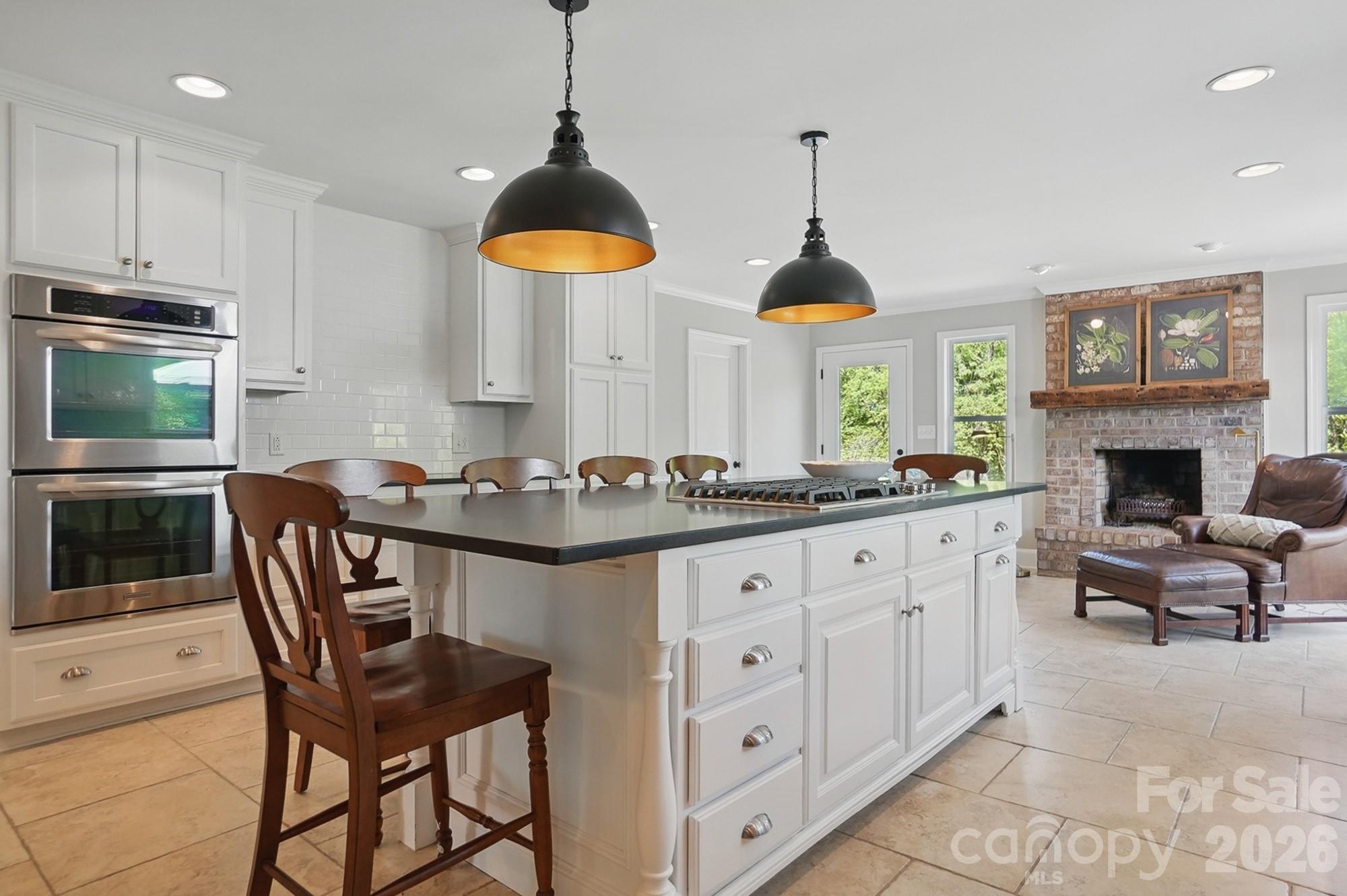 411 Baucom Deese Road Monroe, NC 28110 - Photo 10 of 45 a kitchen with stainless steel appliances granite countertop a stove a sink a dining table and chairs