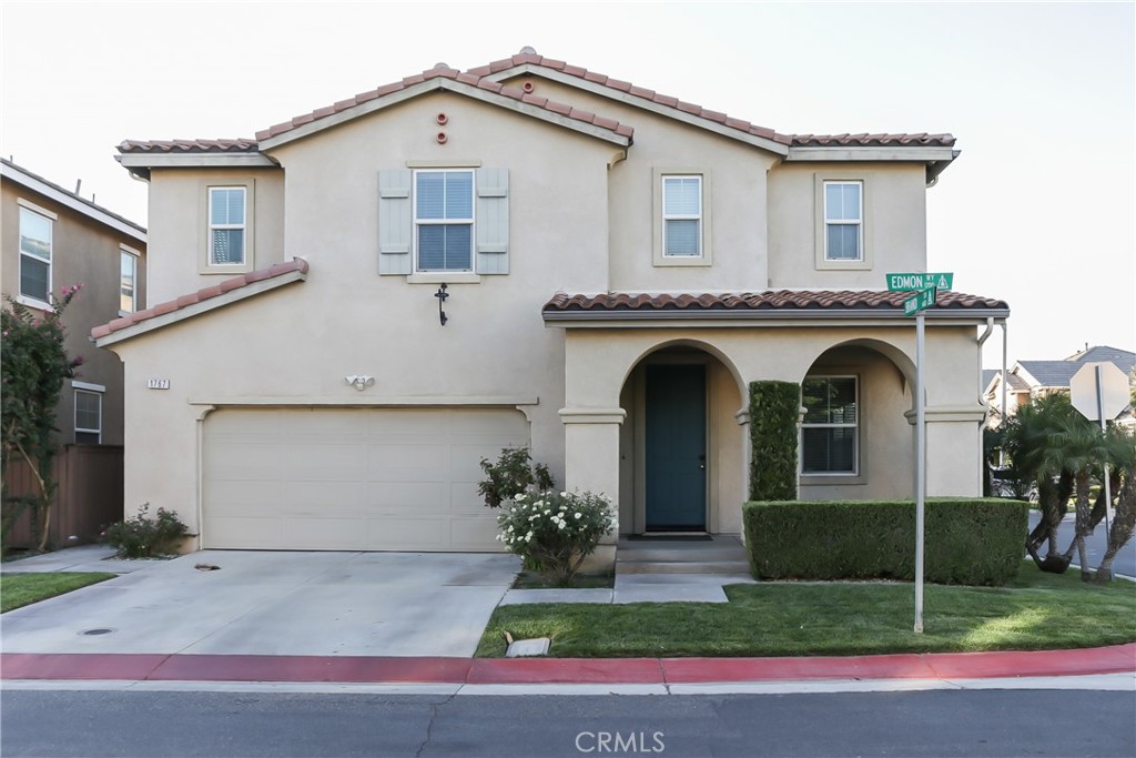 1767 Edmon Way Riverside, CA 92501 - Photo 1 of 1 a view of a white house with a small yard and plants