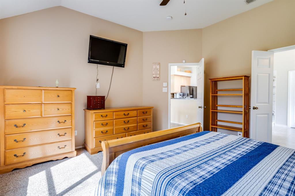 6403 Highland Crest Lane Sachse, TX 75048 - Photo 15 of 40 Bedroom featuring carpet flooring, stainless steel fridge with ice dispenser, and ceiling fan
