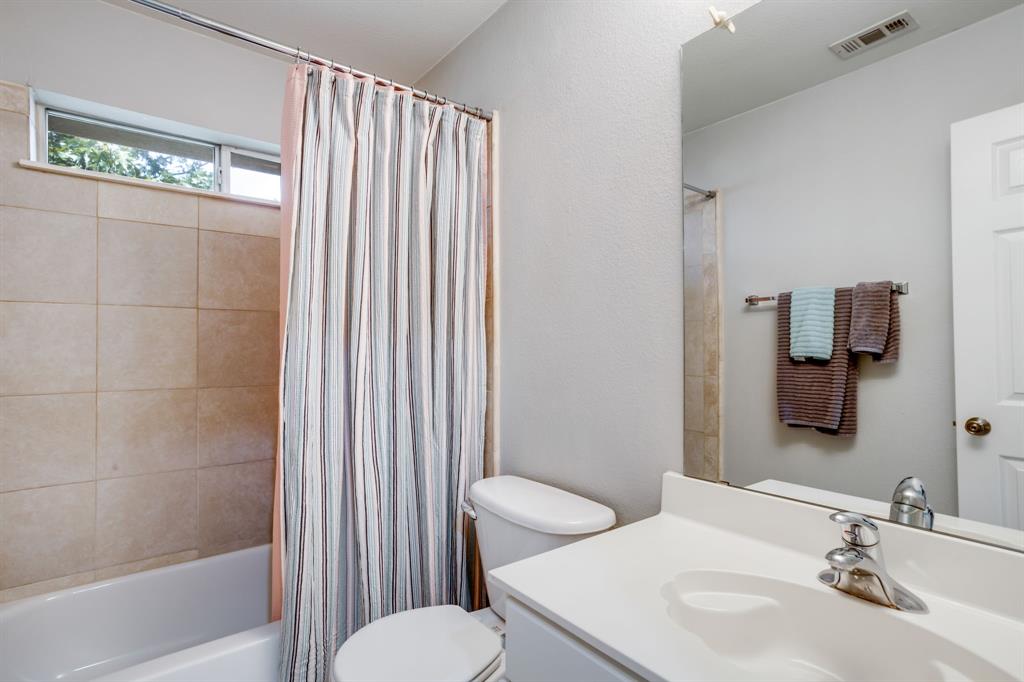 6403 Highland Crest Lane Sachse, TX 75048 - Photo 22 of 40 Bathroom featuring vanity, shower / tub combo, and a textured wall
