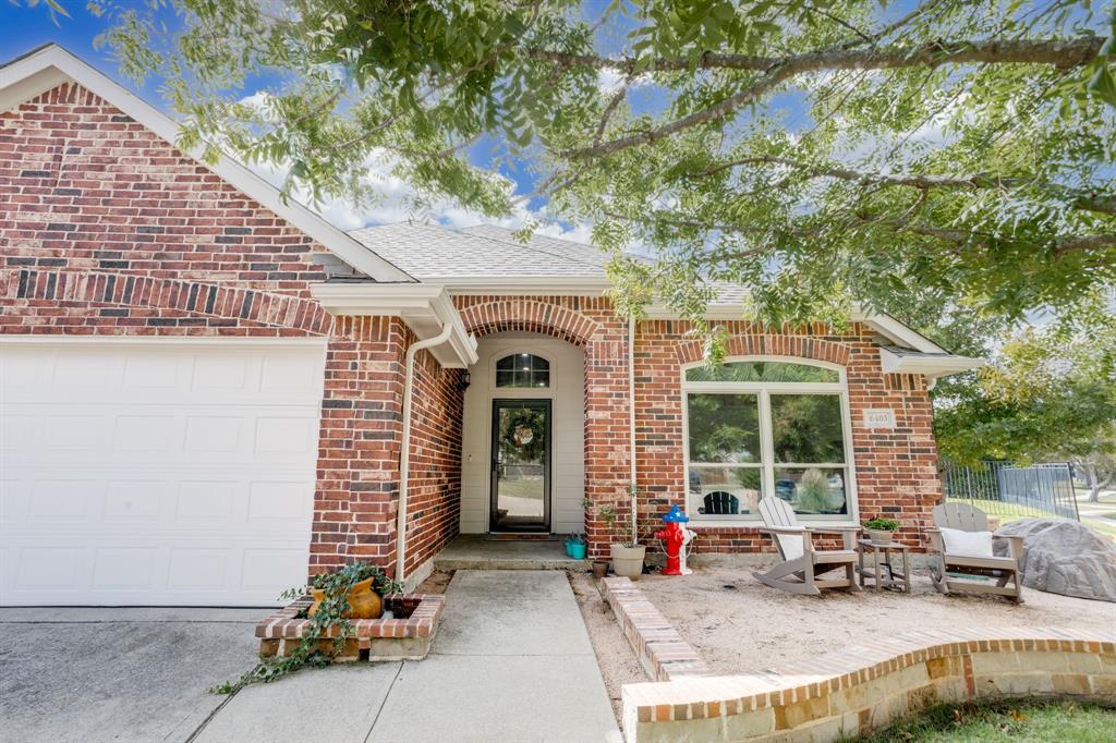 6403 Highland Crest Lane Sachse, TX 75048 - Photo 5 of 40 Property entrance featuring an attached garage, brick siding, and roof with shingles