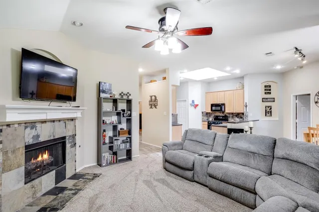 a living room with furniture or kitchen view and a large window
