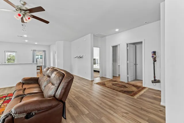 a living room with furniture and wooden floor