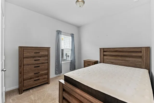 a bedroom with a bed and window