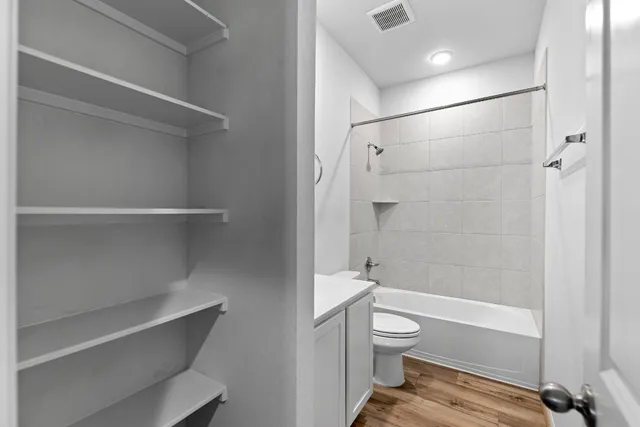 a bathroom with a sink a toilet and bathtub