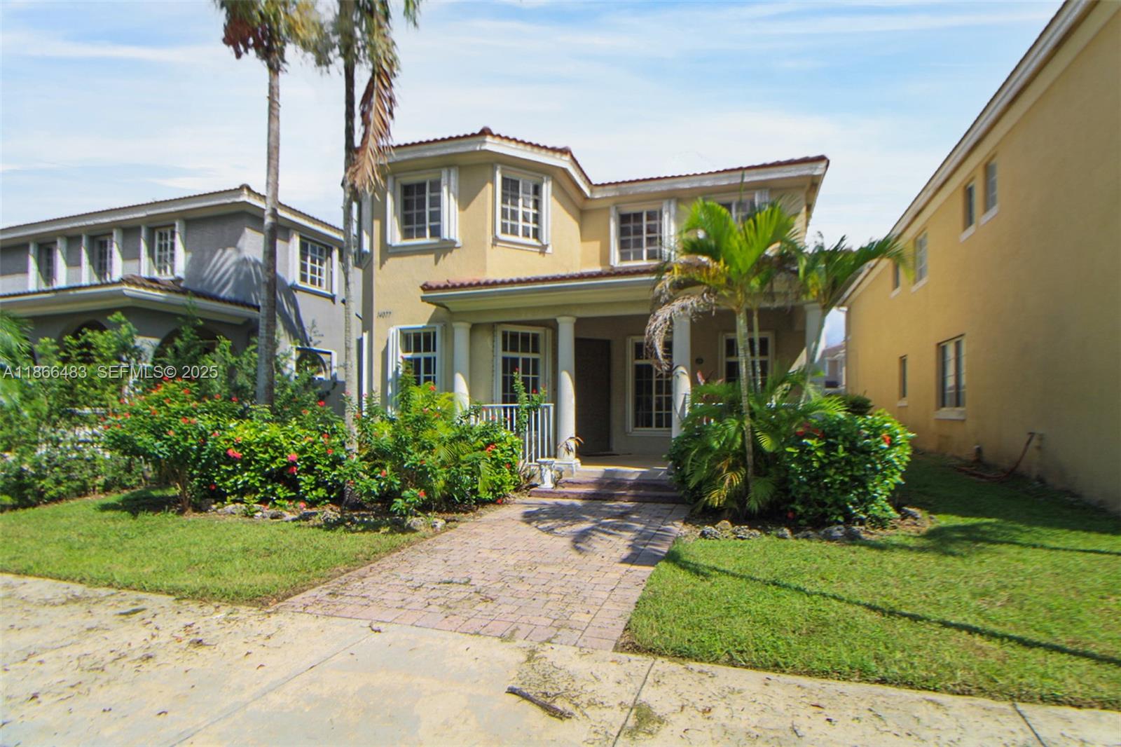 14077 Southwest 274th Terrace Homestead, FL 33032 - Photo 12 of 29 a front view of a house with a garden