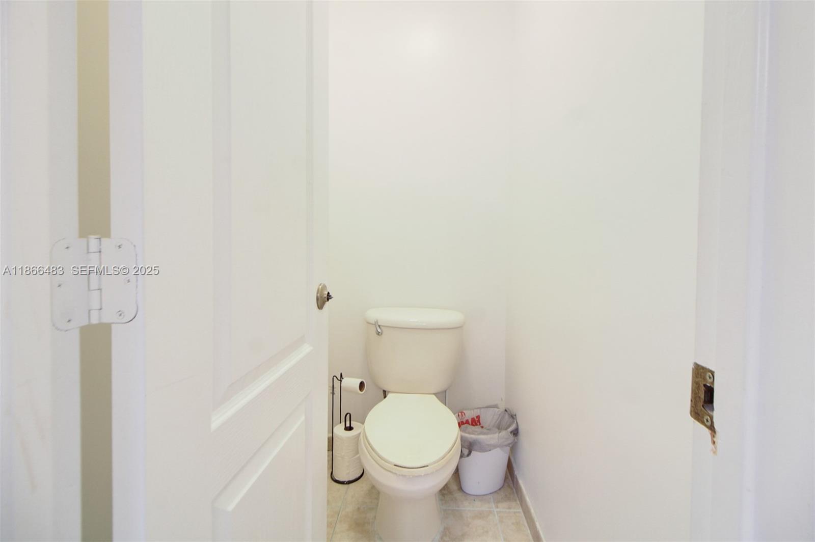 14077 Southwest 274th Terrace Homestead, FL 33032 - Photo 13 of 29 a white toilet sitting next to a white wall