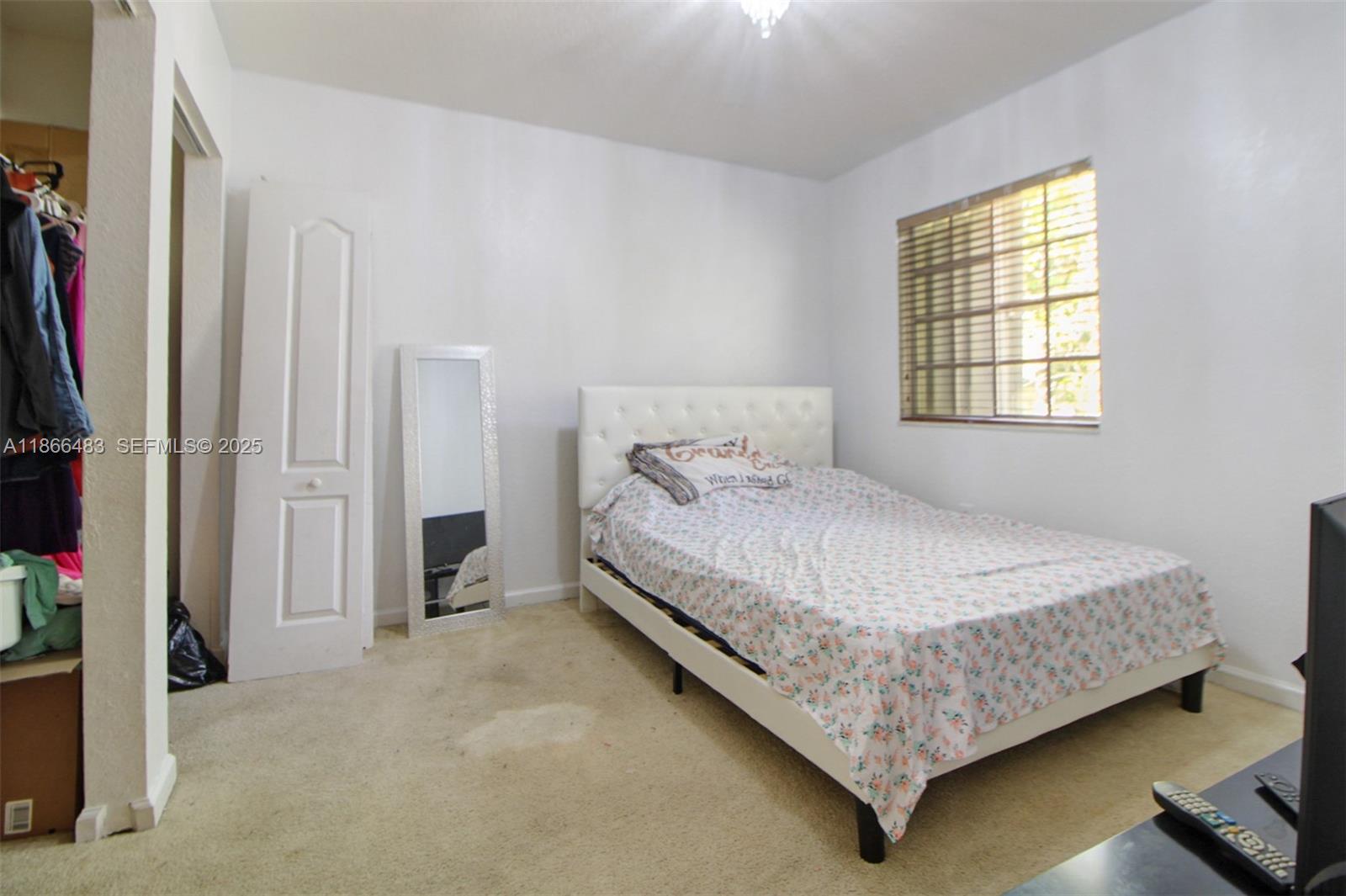 14077 Southwest 274th Terrace Homestead, FL 33032 - Photo 15 of 29 a bedroom with a bed and a window