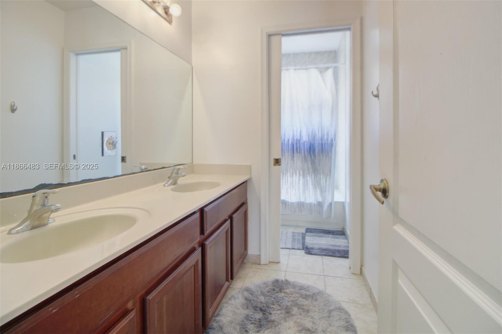 14077 Southwest 274th Terrace Homestead, FL 33032 - Photo 19 of 29 a bathroom with a sink a toilet and shower
