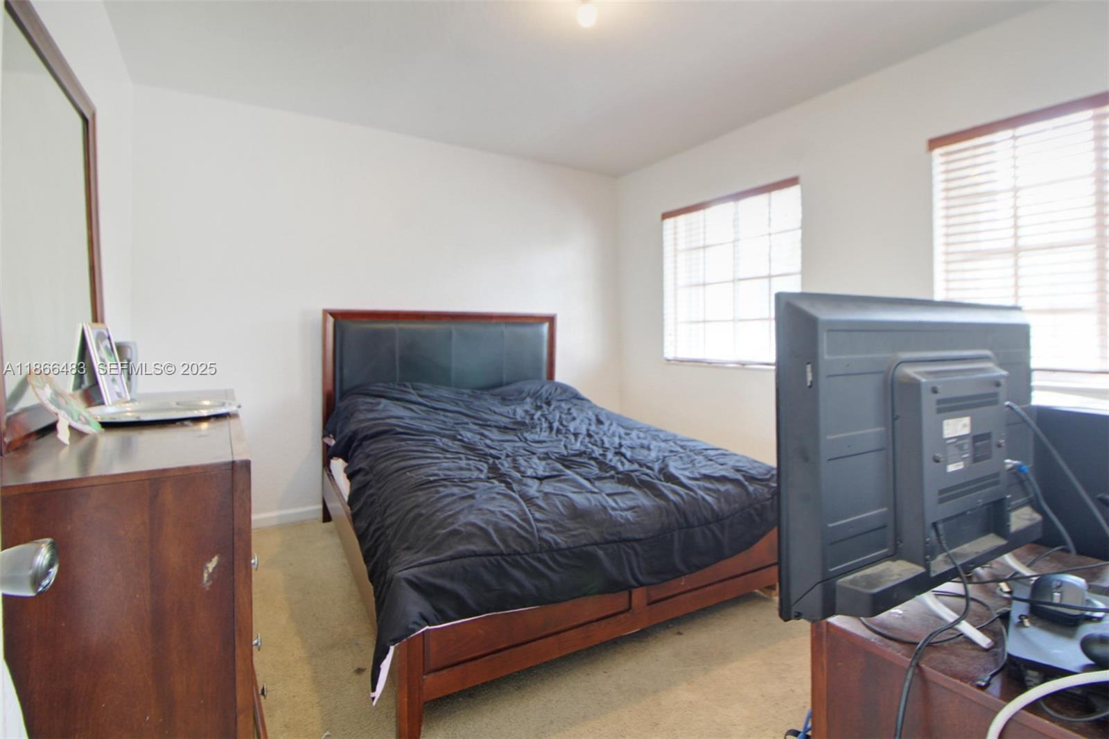 14077 Southwest 274th Terrace Homestead, FL 33032 - Photo 21 of 29 a bedroom with a bed and window
