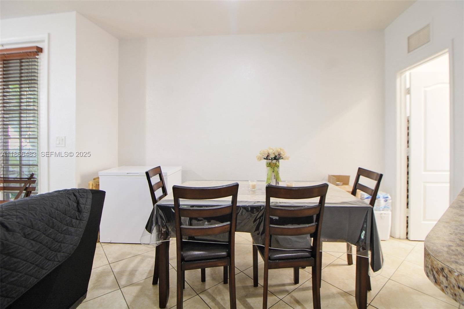14077 Southwest 274th Terrace Homestead, FL 33032 - Photo 24 of 29 a view of a dining room with furniture and wooden floor
