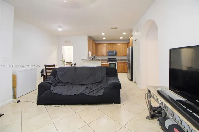 a kitchen with refrigerator a stove and chairs