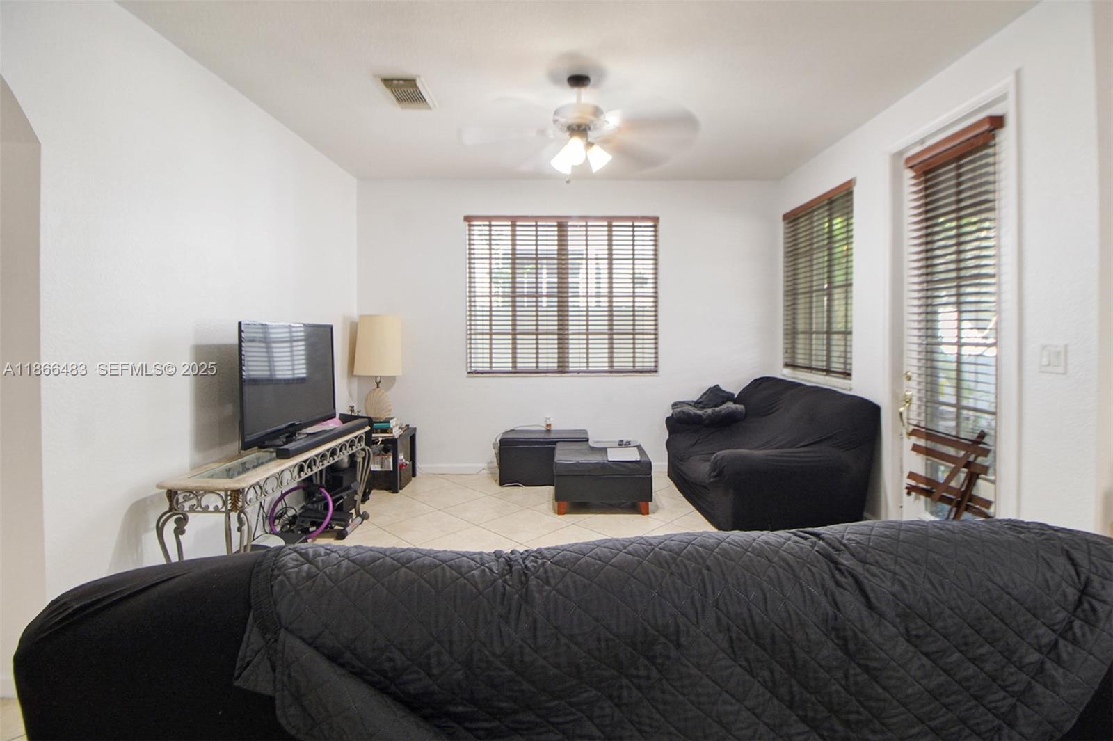 14077 Southwest 274th Terrace Homestead, FL 33032 - Photo 27 of 29 a bedroom with a bed and a flat screen tv