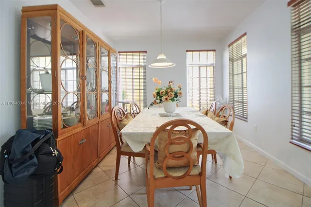 a dining room with furniture and windows