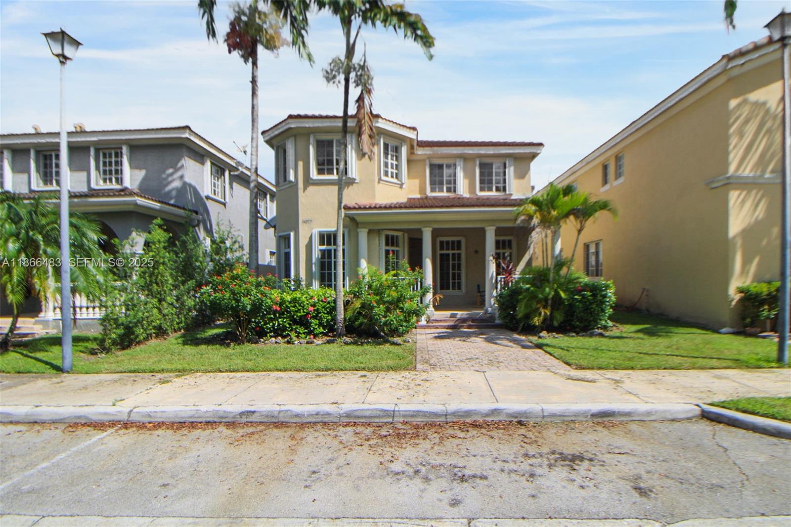 14077 Southwest 274th Terrace Homestead, FL 33032 - Photo 7 of 29 a front view of a house with a garden