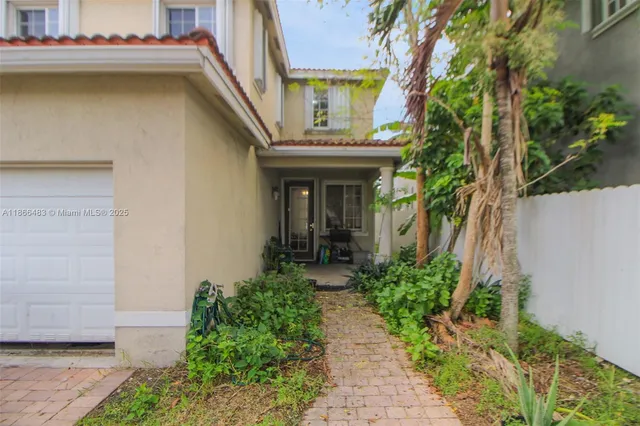 a view of the house with potted plants