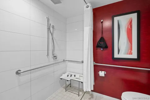 a bathroom with a window and a shower