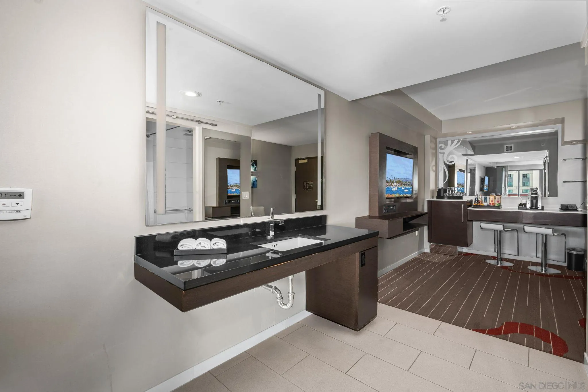 207 Fifth Avenue, Unit 739 San Diego, CA 92101 - Photo 12 of 30 a kitchen with a sink and a stove top oven