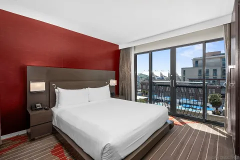 a large bed sitting in a bedroom next to a large window