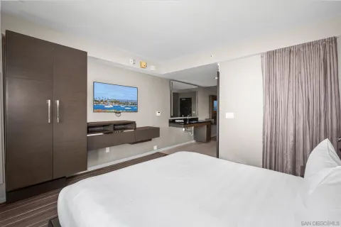 a bedroom with a bed and a large window