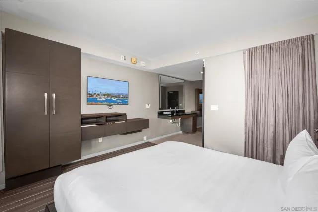 a bedroom with a bed and a large window