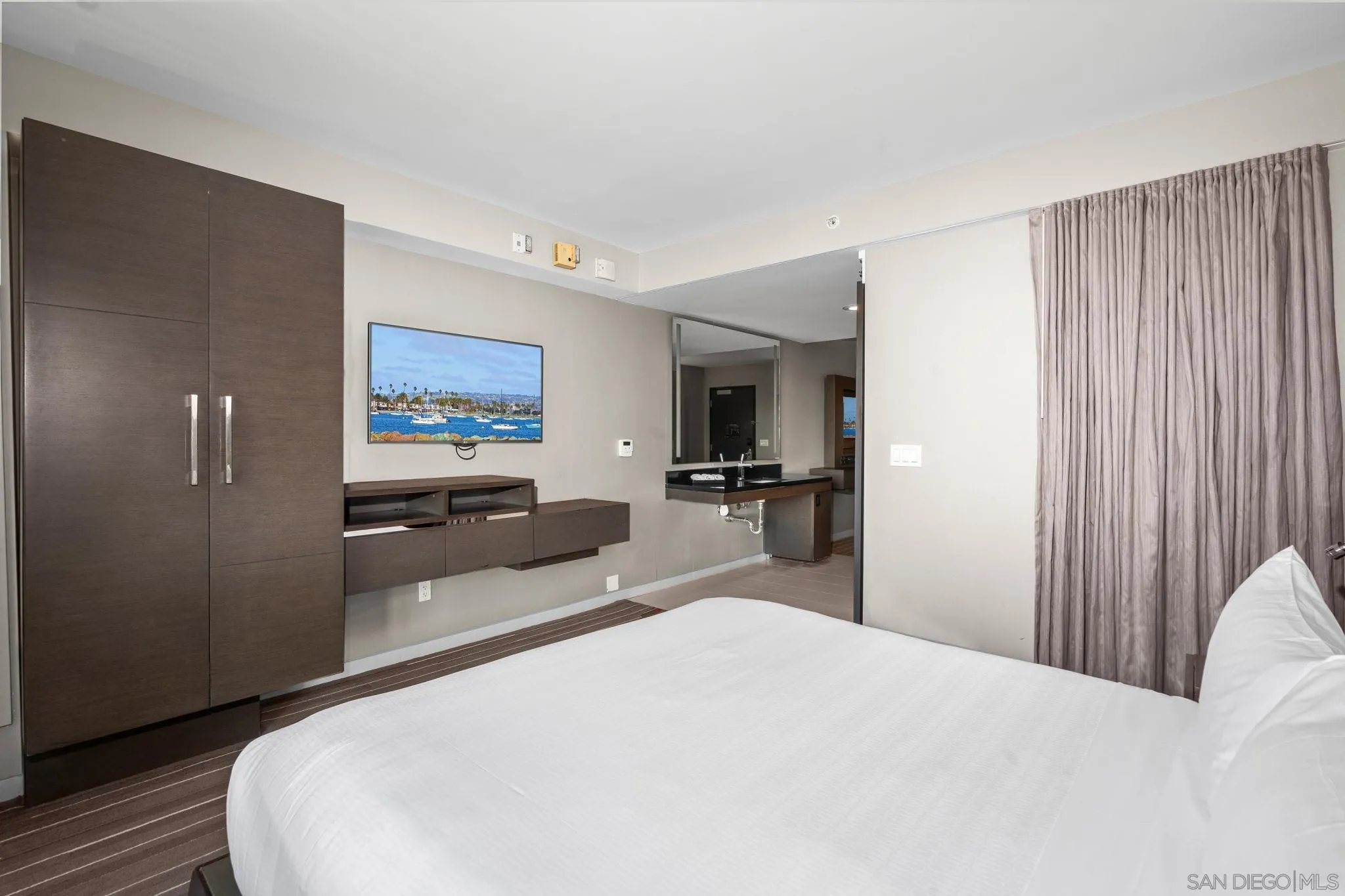 207 Fifth Avenue, Unit 739 San Diego, CA 92101 - Photo 16 of 30 a bedroom with a bed and a large window