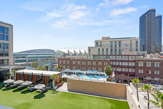 a view of a swimming pool with a patio and a tub