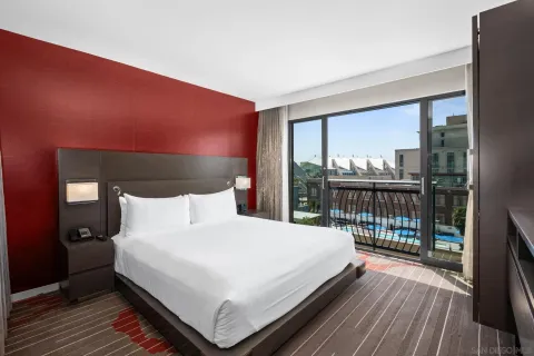 a large bed sitting in a bedroom next to a window