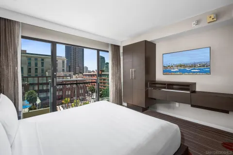 a bedroom with a bed and a large window