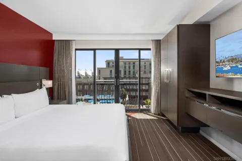 a bedroom with a bed and a television