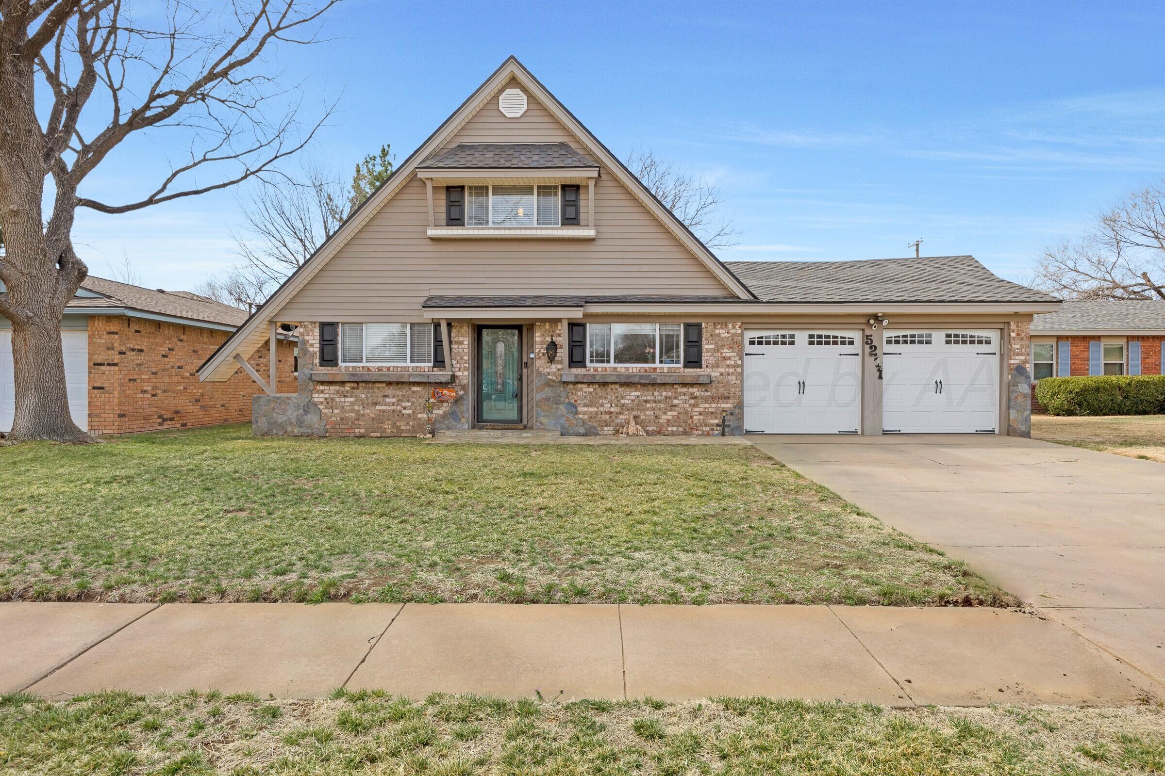 5211 Southwest 36th Avenue Amarillo, TX 79109 - Photo 1 of 22 a front view of a house with garden