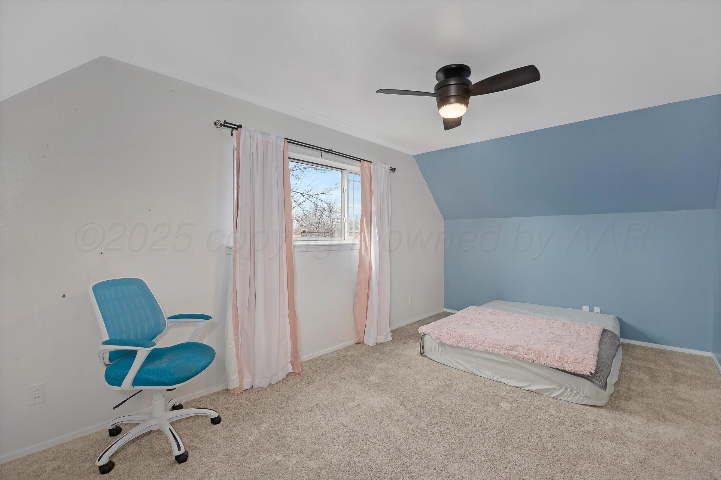 5211 Southwest 36th Avenue Amarillo, TX 79109 - Photo 16 of 22 a bedroom with a bed and a chair